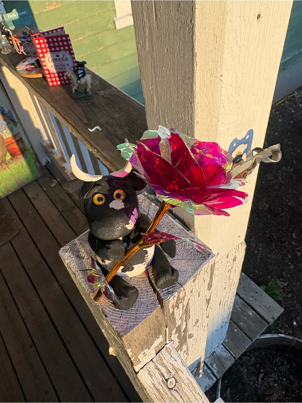 Black Bull Figurine Holding Pink Glass Flower